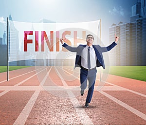 Businessman on the finishing line in competition concept