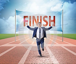 Businessman on the finishing line in competition concept