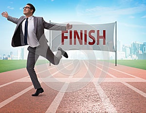 Businessman on the finishing line in competition concept