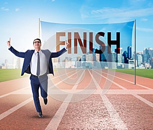 Businessman on the finishing line in competition concept