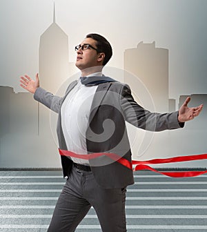 Businessman on the finishing line in competition concept