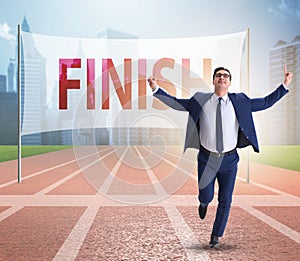 Businessman on the finishing line in competition concept