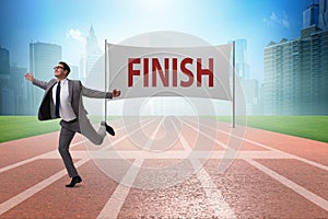 The businessman on the finishing line in competition concept