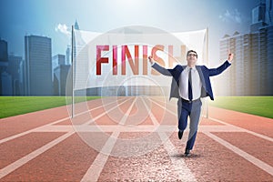 The businessman on the finishing line in competition concept