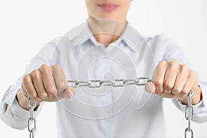 Businessman firmly holds chrome chain in hands