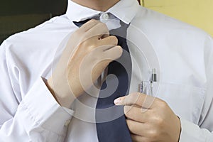 Businessman is fixing a blue tie