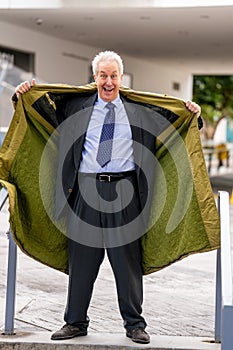 Businessman flashing open his trenchcoat to show his suit photo