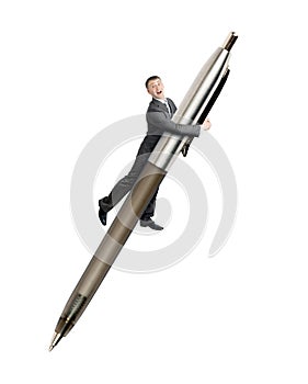 Businessman flying on big pen