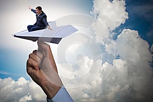 The businessman flying on paper plane in business concept