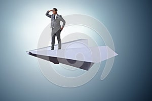 The businessman flying on paper plane in business concept