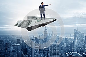 The businessman flying on paper plane in business concept