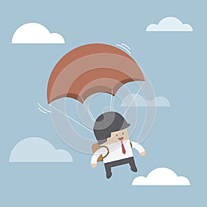 Businessman is flying with parachute