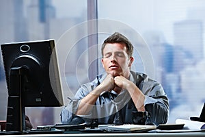 Businessman focusing on problems in office photo