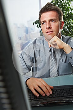 Businessman focusing on problems in office