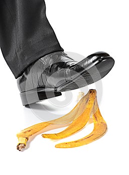 Businessman foot on a banana peel