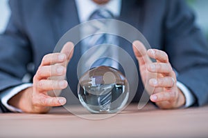 Businessman forecasting a crystal ball