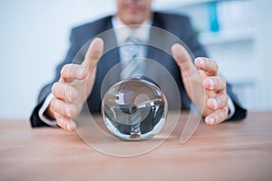 Businessman forecasting a crystal ball photo