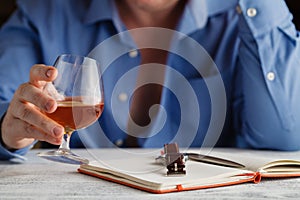 Businessman in formal dress relax with glass of cognac