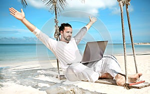 Businessman freelance on beach with laptop