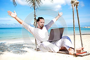 Businessman freelance on beach with laptop