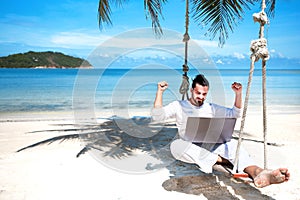 Businessman freelance on beach with laptop