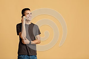 Businessman, freelance, employee speaks on phone. Cute smiling millennial man talking on smartphone