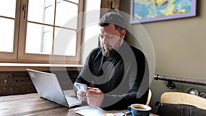 Businessman freelancer typing on laptop during work in cafe