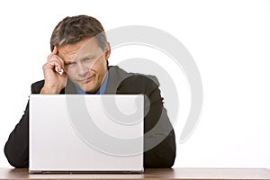 Businessman Frowning While Looking At Laptop