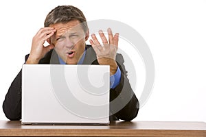 Businessman Frowning While Looking At Laptop