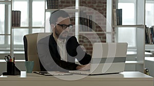 Businessman in funny glasses typing on keyboard