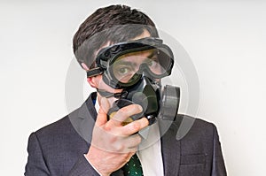 Businessman with gas mask on white