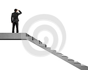 Businessman gazing on top of concrete stairs