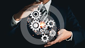 Businessman with gears on virtual interface. Business process analysis and innovation with global network connectivity.