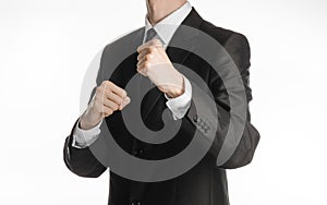 Businessman and gesture topic: a man in a black suit holding his fists in front of him, business struggle