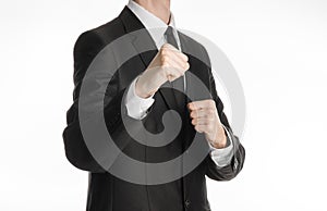 Businessman and gesture topic: a man in a black suit holding his fists in front of him, business struggle