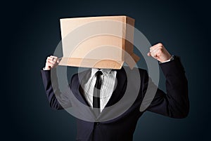 Businessman gesturing with a cardboard box on his head