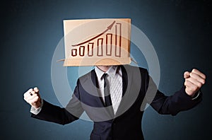 Businessman gesturing with a cardboard box on his head with diagram