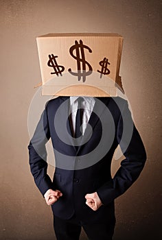 Businessman gesturing with a cardboard box on his head with dollar signs