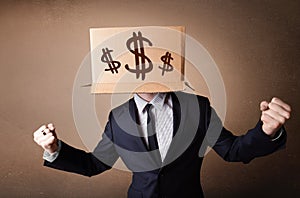 Businessman gesturing with a cardboard box on his head with dollar signs