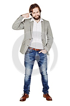 Businessman gesturing with his finger against temple asking are