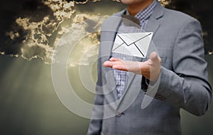 Businessman get email in hand with shiny sky