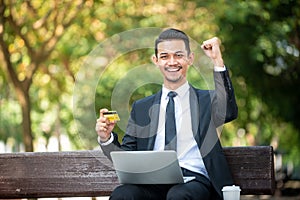 Businessman gets a Good deal on the internet.  E-commerce and online purchase. Outdoor setting