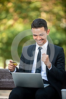Businessman gets a Good deal on the internet.  E-commerce and online purchase. Outdoor setting
