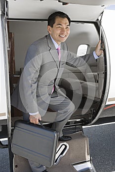 Businessman Getting Down From Private Airplane