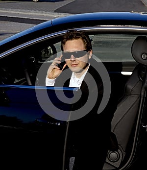 Businessman getting out of a car