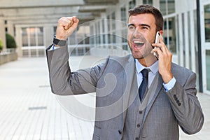 Businessman getting phenomenal news on the phone