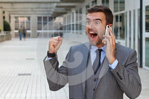 Businessman getting phenomenal news on the phone