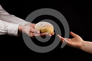 Businessman giving bread to a woman. Helping Hand Concept.