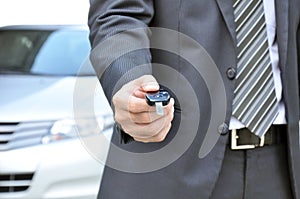 Businessman giving a car key - car sale & rental business concept