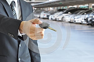 Businessman giving a car key - car sale & rental concept